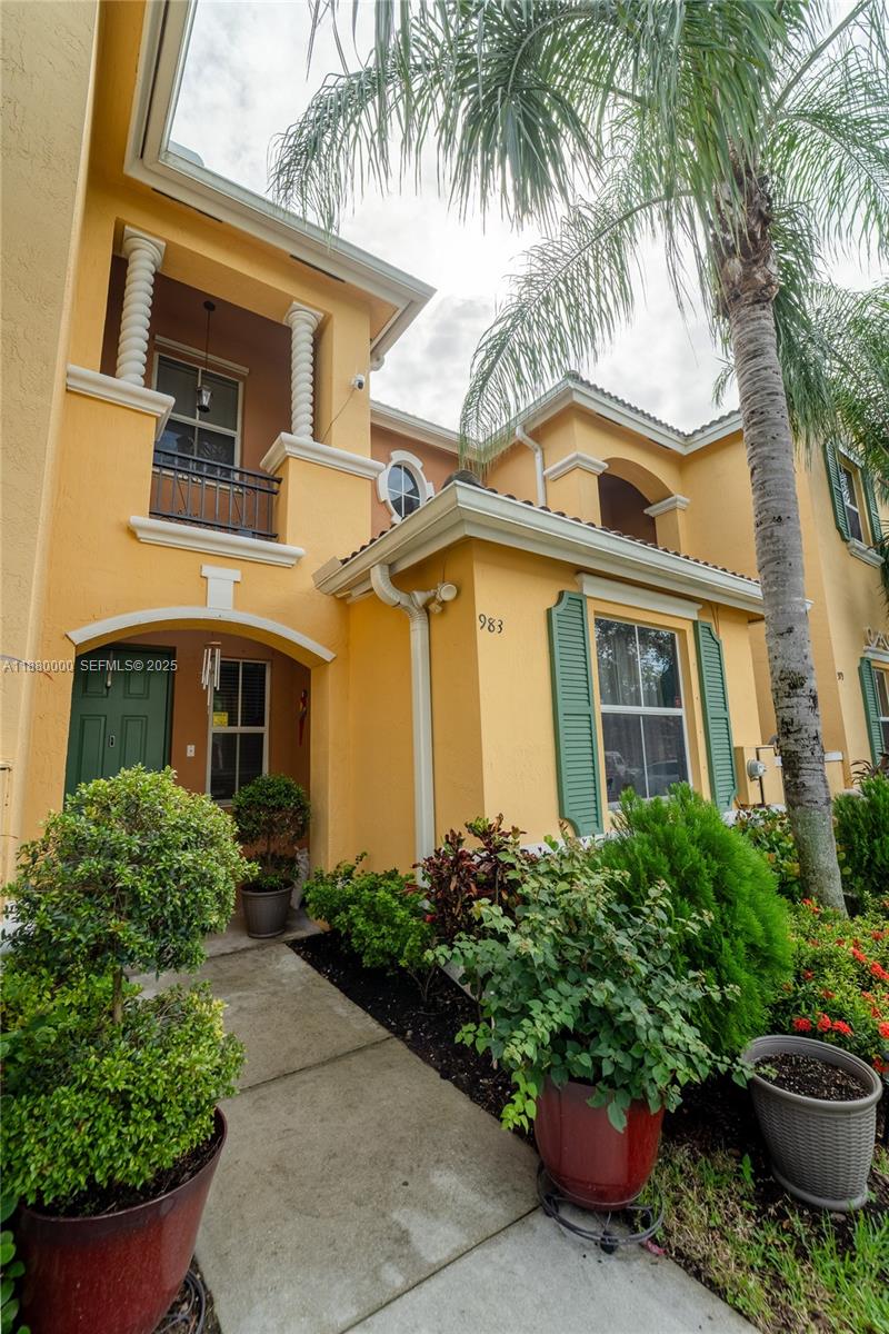 983 Northeast 42nd Place Homestead, FL 33033 - Photo 7 of 51 a front view of a house with a garden