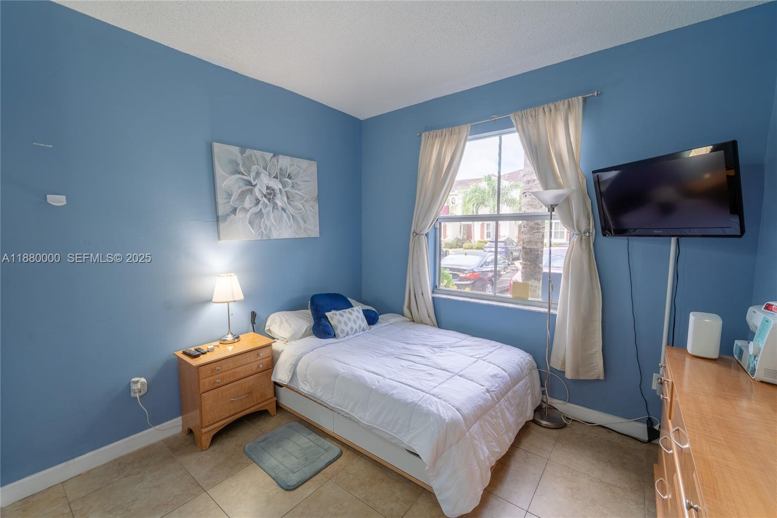 983 Northeast 42nd Place Homestead, FL 33033 - Photo 8 of 51 a bedroom with a bed and a flat screen tv