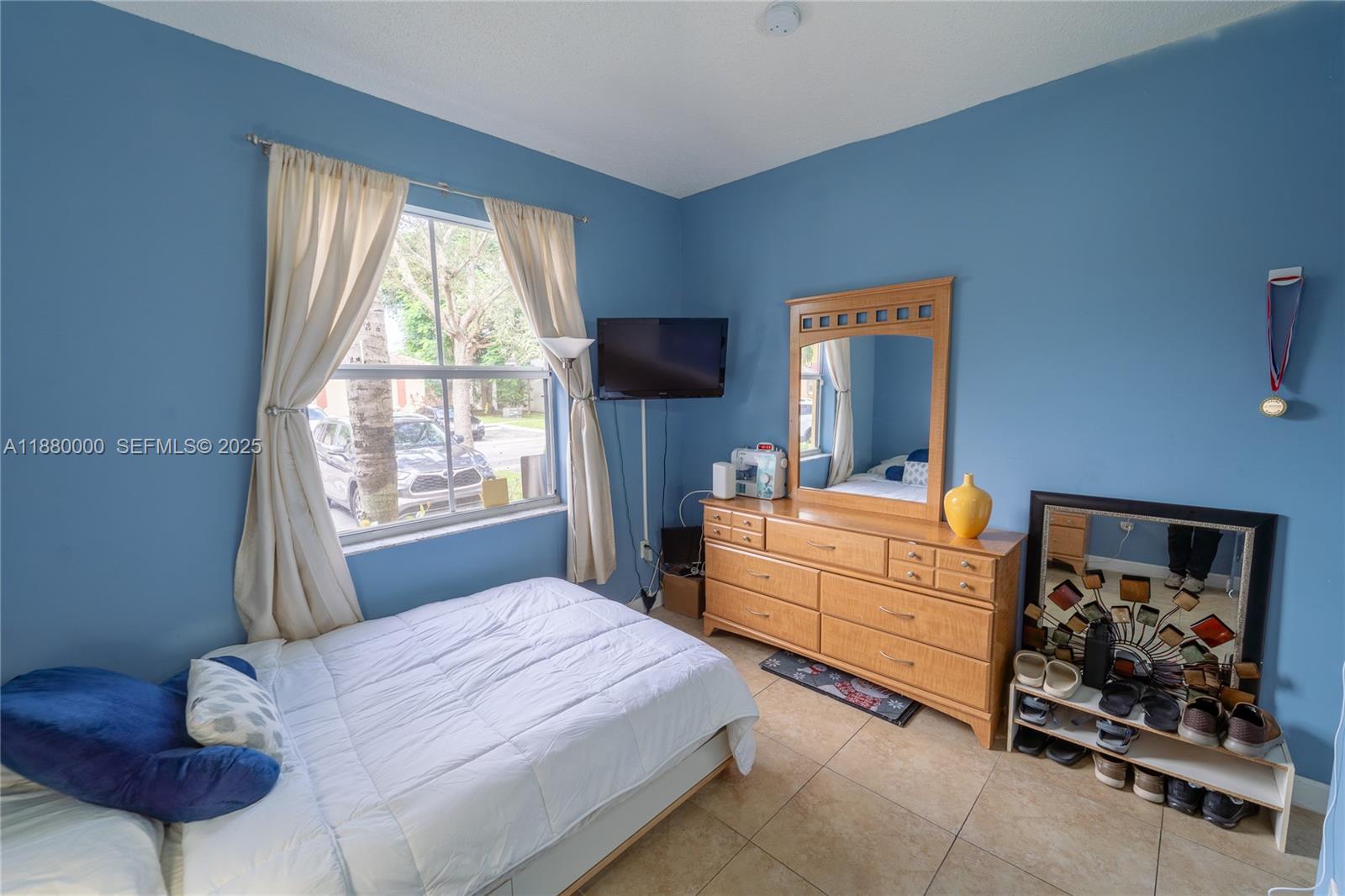 983 Northeast 42nd Place Homestead, FL 33033 - Photo 9 of 51 a bedroom with a bed and a window