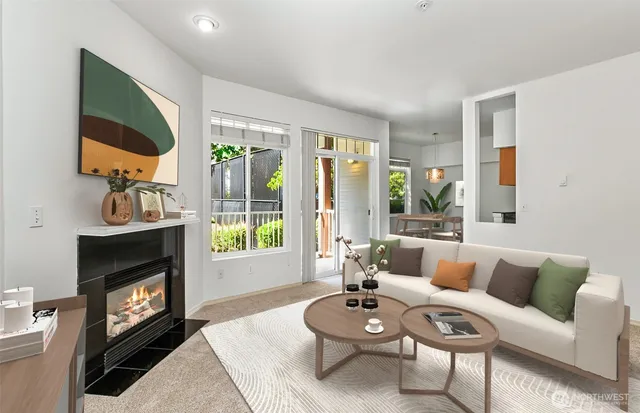 a living room with furniture a fireplace a flat screen tv and a large window