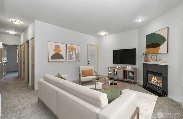 a living room with furniture a flat screen tv and a fireplace