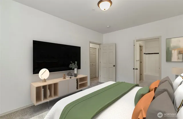 a bedroom with a bed tv and a window