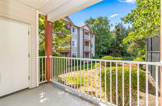 a view of a chairs and table in the balcony