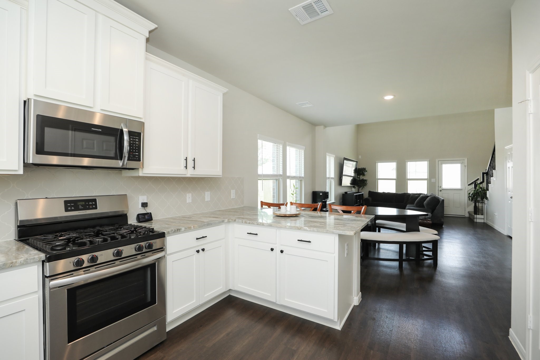 2401 Sequoia Grove Drive Rosharon, TX 77583 - Photo 39 of 39 KITCHEN- OPEN FLOOR PLAN. NOTE BAR AREA... the floors are so cohesive and stunning. NOTE UPGRADE