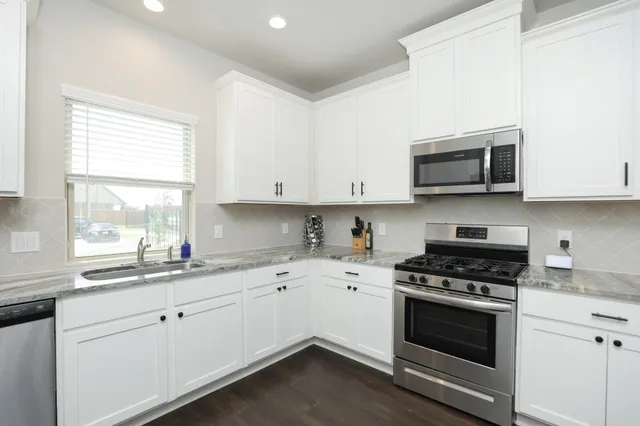 a view of living room with granite countertop furniture and fireplace