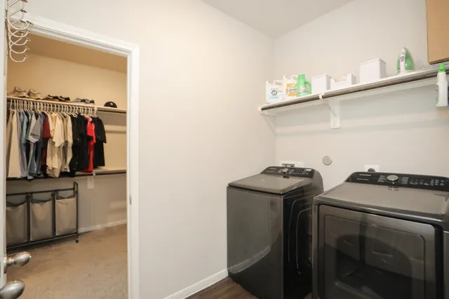 a bathroom with a toilet sink vanity and mirror
