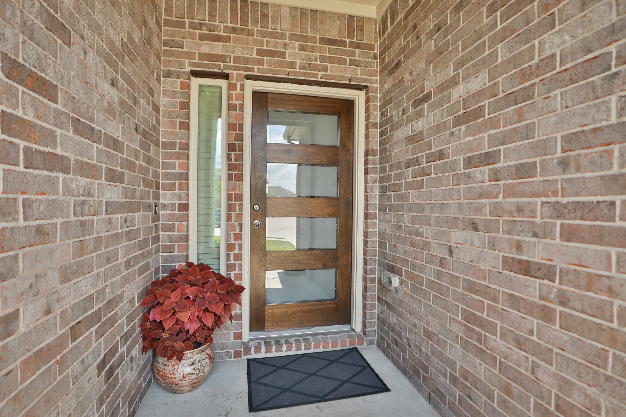 2401 Sequoia Grove Drive Rosharon, TX 77583 - Photo 2 of 39 The entry has a HIGH END Custom door which leads to a UNIQUE entry that greats guests with warmth and high end warmth and class.