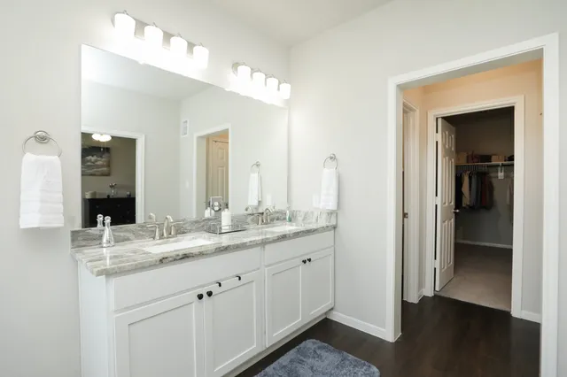 a white bath tub sitting next to a shower