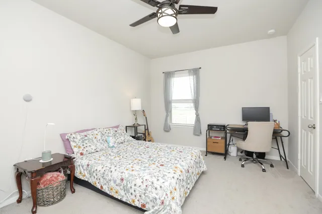 a bathroom with a granite countertop sink a toilet and shower