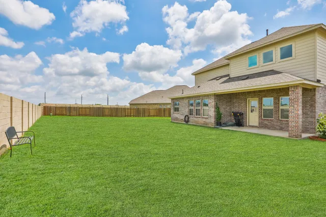 a view of yard with swimming pool and green space
