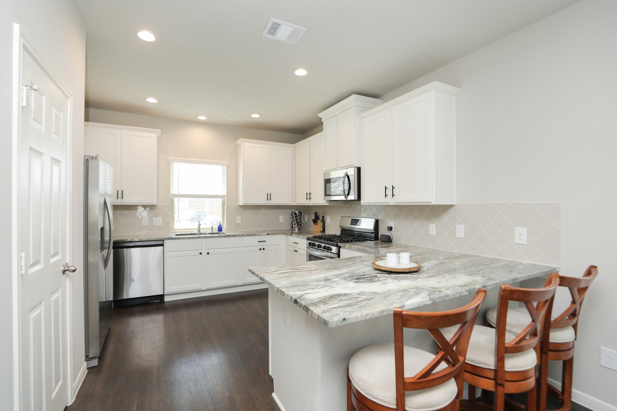 2401 Sequoia Grove Drive Rosharon, TX 77583 - Photo 9 of 39 KITCHEN- This is a CHEFS KITCHEN WITH LARGE PANTRY and COUNTER SPACE that WRAPS AROUND. SO much STORAGE. STUNNING COUNTERS... recessed lights...