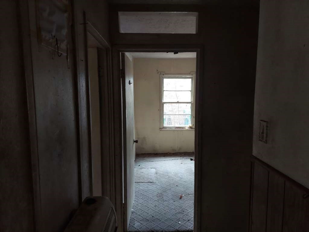 406 Jenkins Street Daingerfield, TX 75638 - Photo 4 of 9 a view of an empty room with a closet
