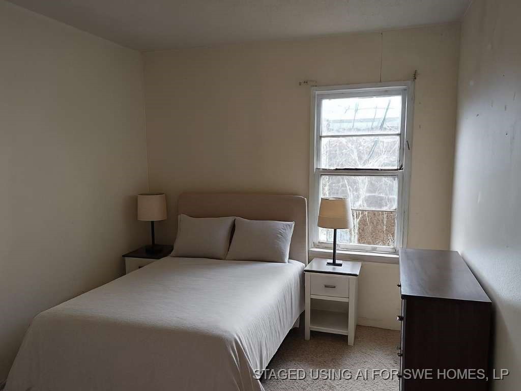406 Jenkins Street Daingerfield, TX 75638 - Photo 6 of 9 a bedroom with a bed and a window