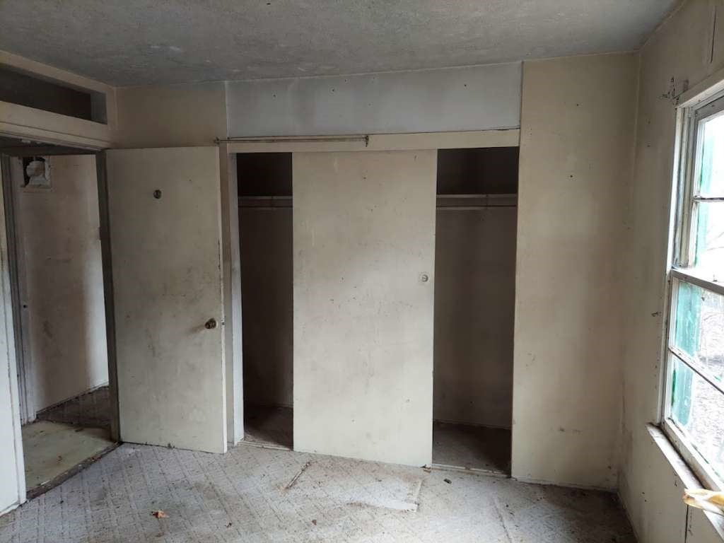406 Jenkins Street Daingerfield, TX 75638 - Photo 7 of 9 an empty room with windows