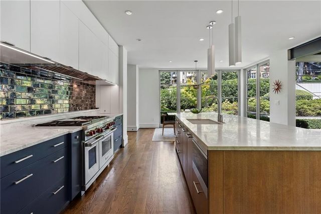 a living room with furniture a large window and a fireplace