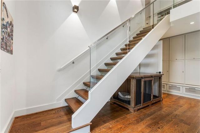a living room with a bed furniture and a large window