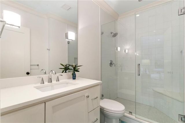 a front view of house and yard with beautiful flowers and green space