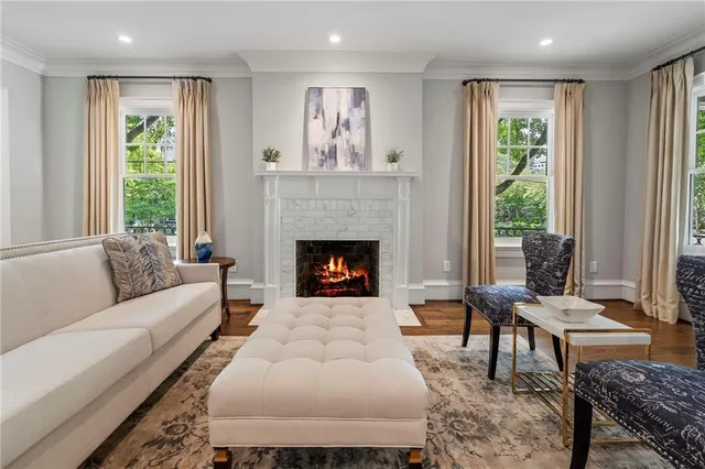 a living room with furniture fireplace and window