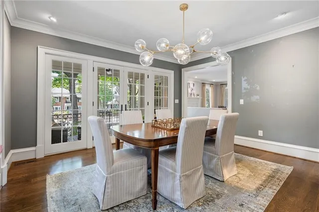 a view of a dining room with furniture wooden floor and chandelier