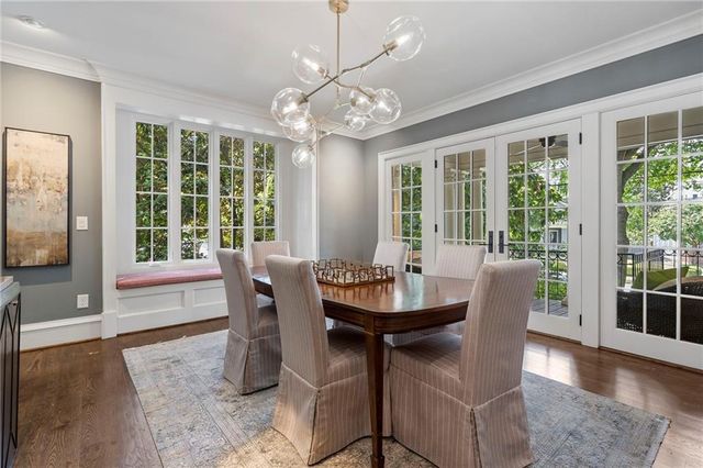 a view of a dining room with furniture wooden floor and chandelier
