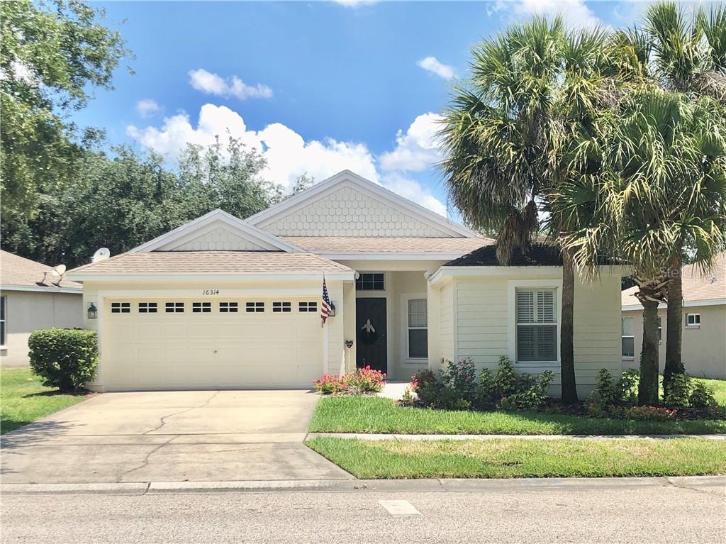 16314 Dorman Road Lithia, FL 33547 - Photo 1 of 1 a view of a white house with a yard and potted plants