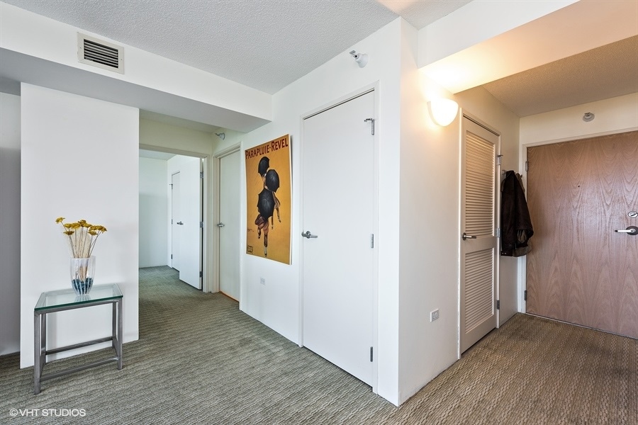 1720 Maple Avenue, Unit 2160 Evanston, IL 60201 - Photo 2 of 45 a view of a hallway with wooden floor and furniture