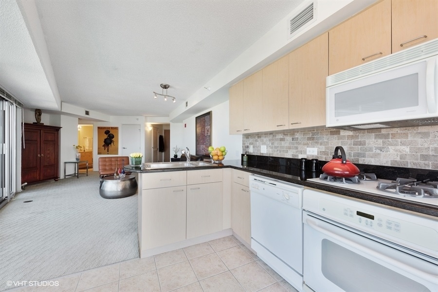 1720 Maple Avenue, Unit 2160 Evanston, IL 60201 - Photo 6 of 45 a kitchen filled with white cabinets and appliances