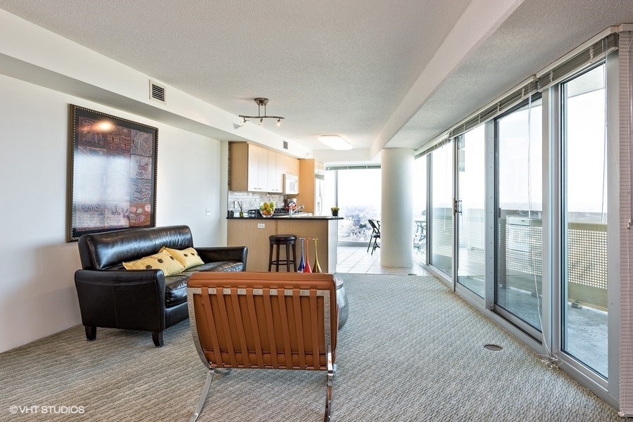 1720 Maple Avenue, Unit 2160 Evanston, IL 60201 - Photo 7 of 45 a living room with furniture and a fireplace