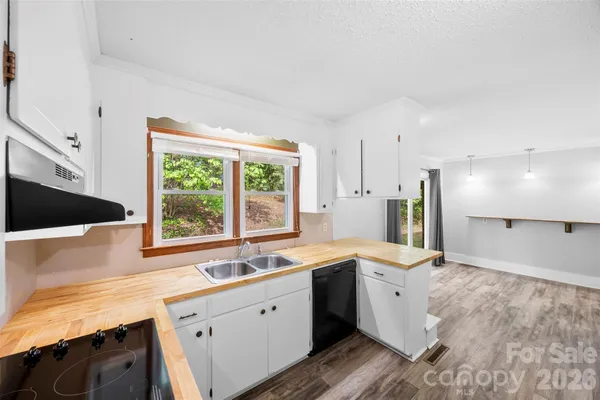 a view of a workspace with furniture and wooden floor
