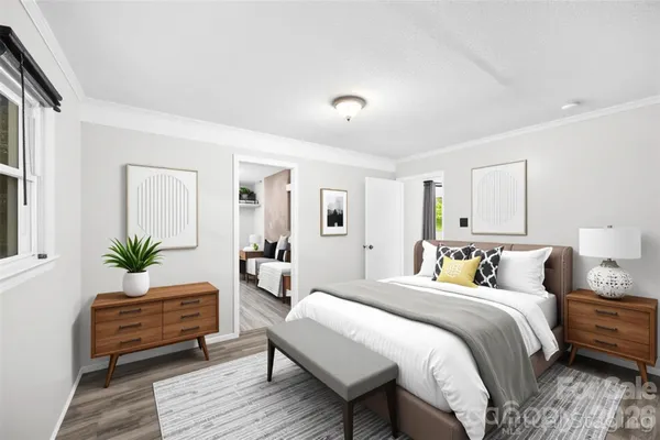 a bedroom with a bed and a window with mirror