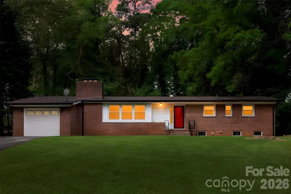 a front view of a house with a garden and yard