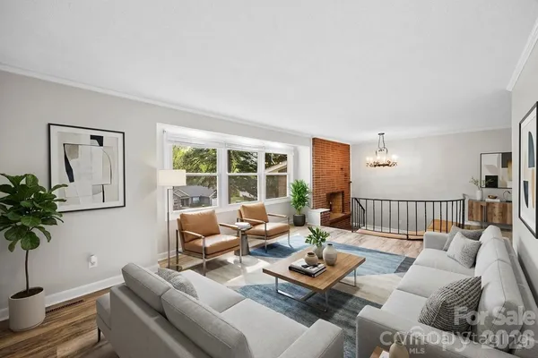 a living room with furniture window and wooden floor
