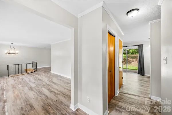 a view of hallway with wooden floor