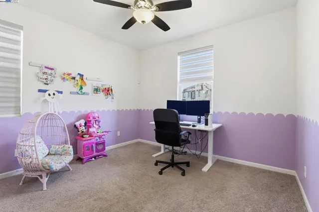 a bedroom with a workspace