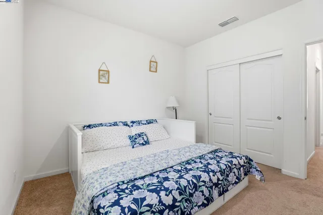 a bedroom with a bed and a night stand