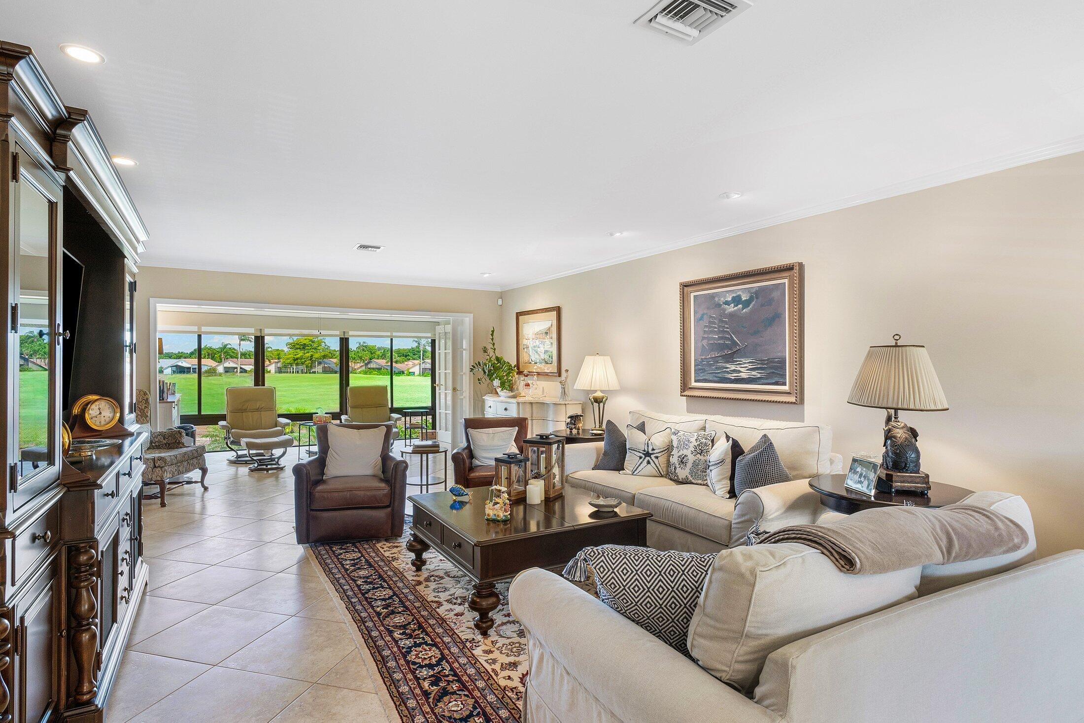 10093 Quail Covey Road, Unit HIBISCUS N Boynton Beach, FL 33436 - Photo 11 of 34 a living room with furniture and a large window