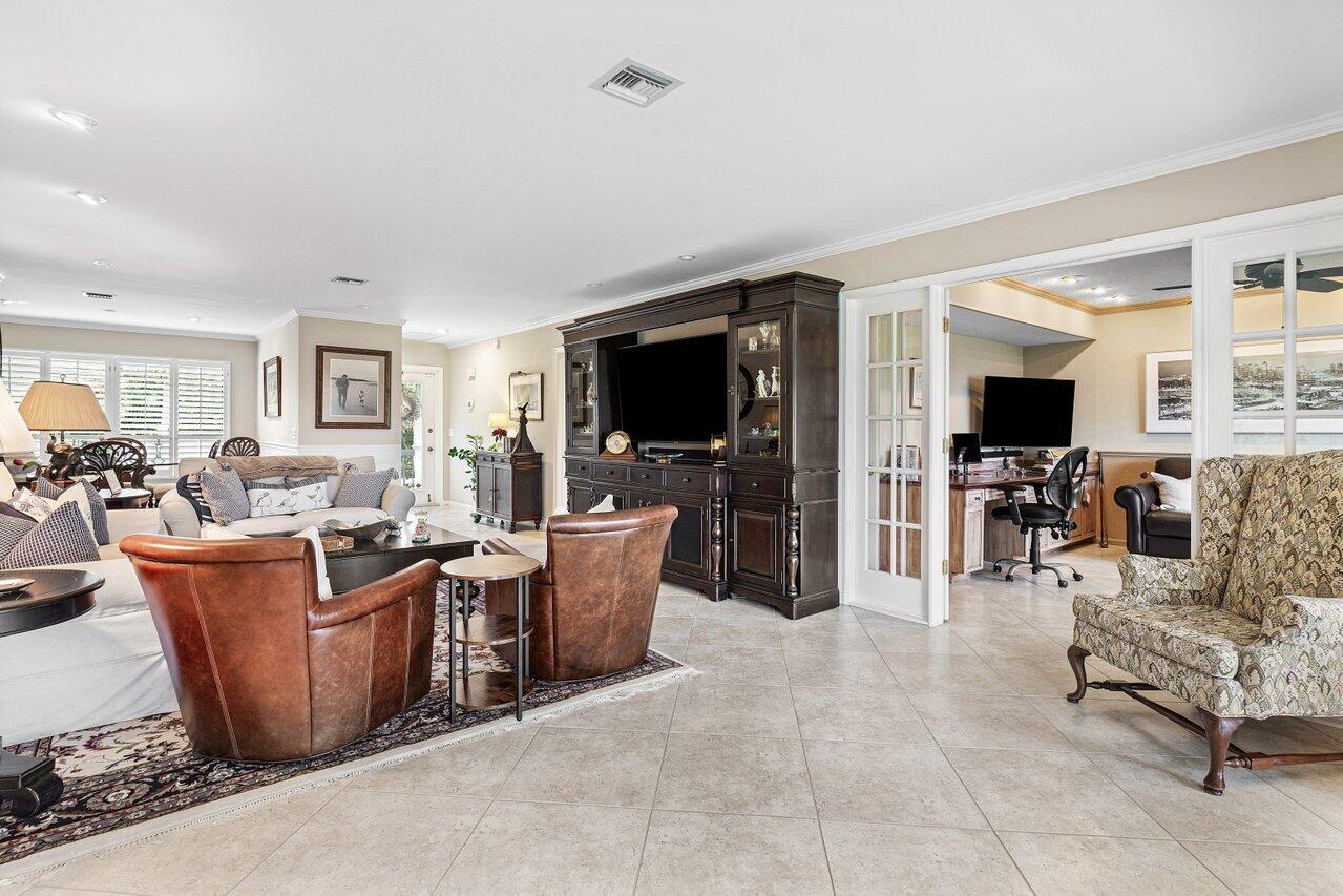 10093 Quail Covey Road, Unit HIBISCUS N Boynton Beach, FL 33436 - Photo 15 of 34 a living room with furniture a flat screen tv and large window