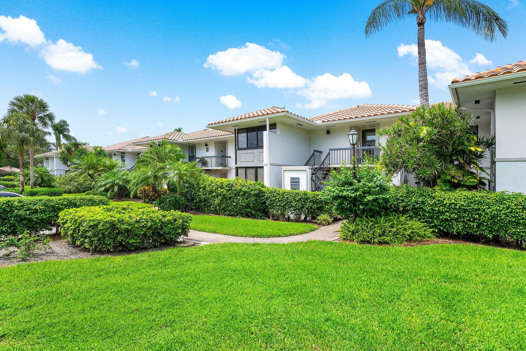 10093 Quail Covey Road, Unit HIBISCUS N Boynton Beach, FL 33436 - Photo 34 of 34 a front view of a house with a yard
