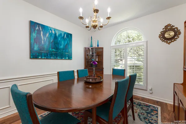 a bedroom with a bed lamps and a chandelier