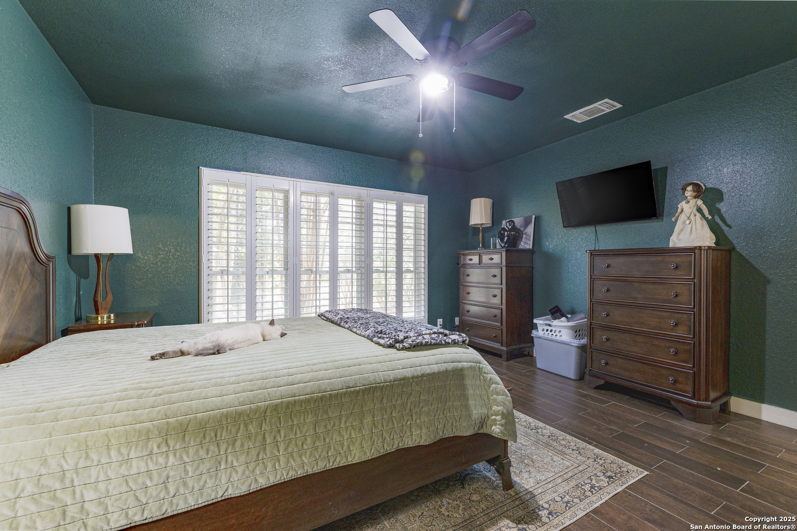 922 Hedgestone Drive San Antonio, TX 78258 - Photo 14 of 40 a bedroom with a bed and wooden floor