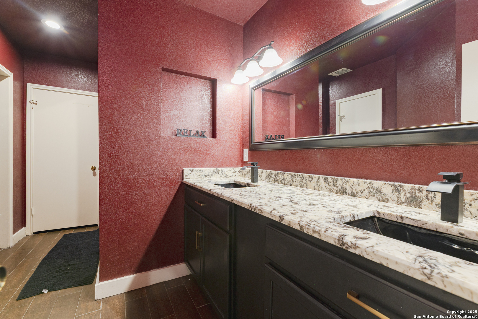 922 Hedgestone Drive San Antonio, TX 78258 - Photo 15 of 40 a bathroom with a granite countertop sink and a mirror