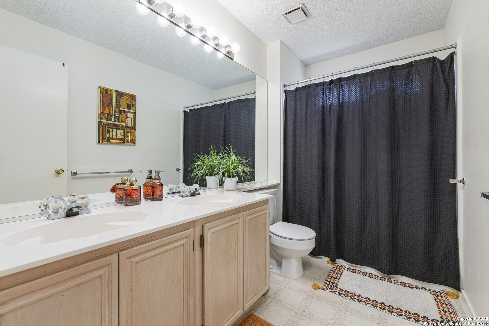 922 Hedgestone Drive San Antonio, TX 78258 - Photo 17 of 40 a bathroom with a sink and a mirror
