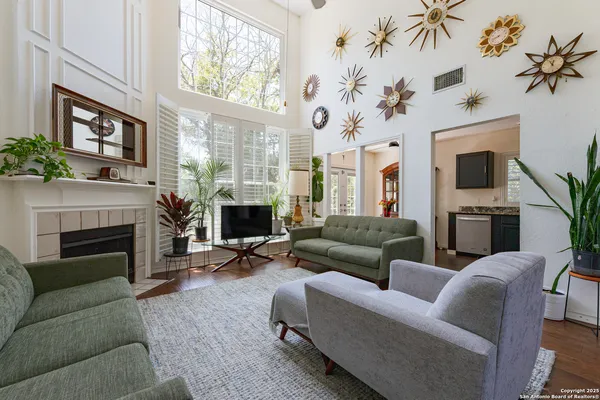 a living room with furniture a fireplace and a flat screen tv