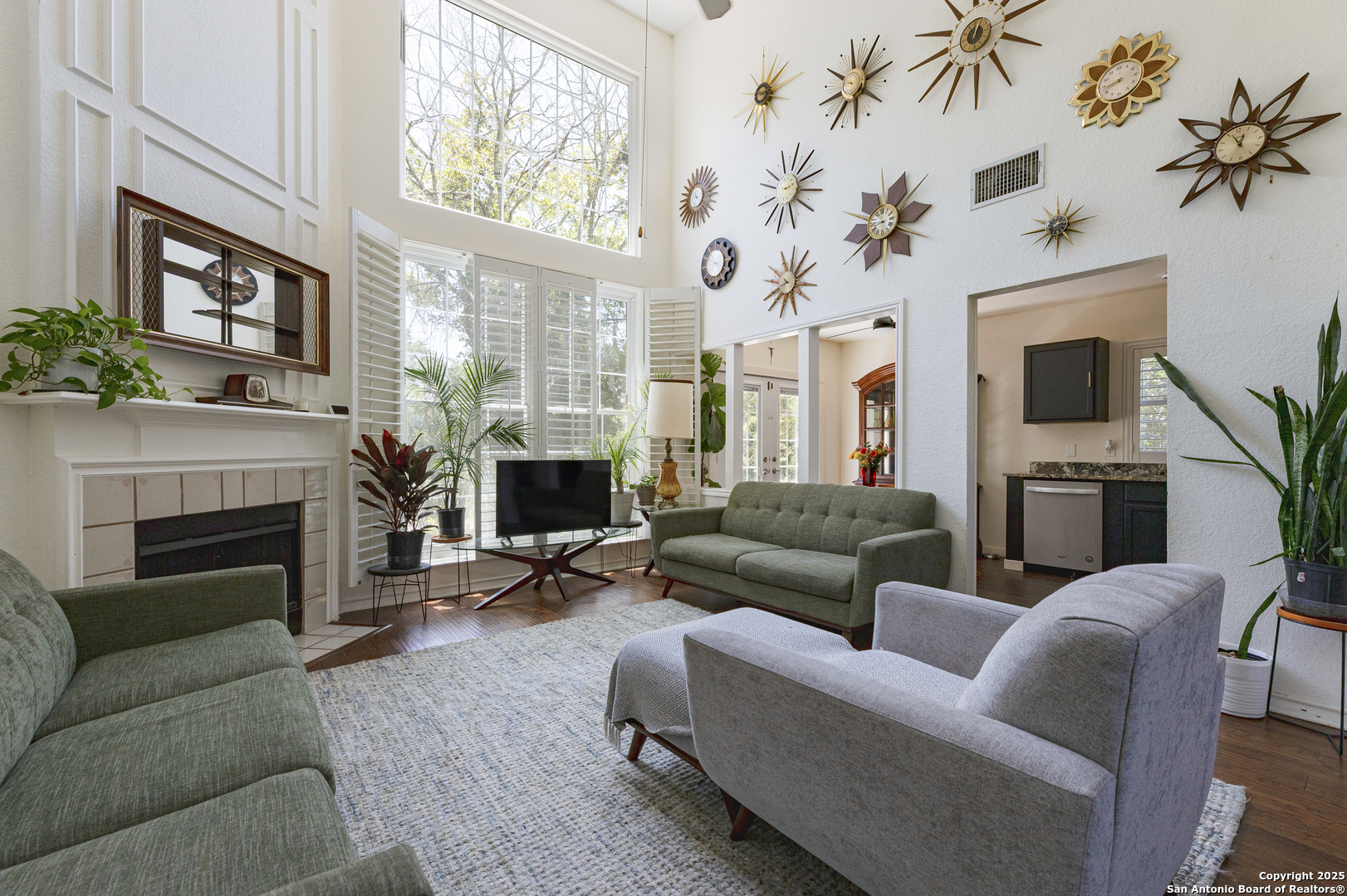 922 Hedgestone Drive San Antonio, TX 78258 - Photo 2 of 40 a living room with furniture a fireplace and a flat screen tv