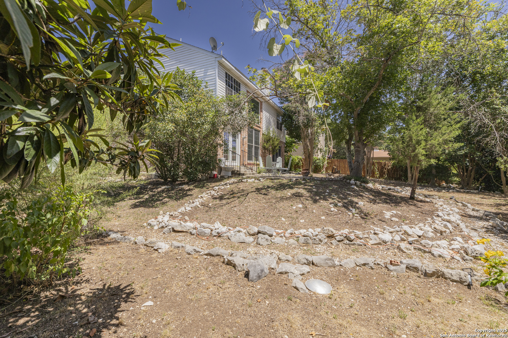 922 Hedgestone Drive San Antonio, TX 78258 - Photo 28 of 40 a backyard of a house with large trees