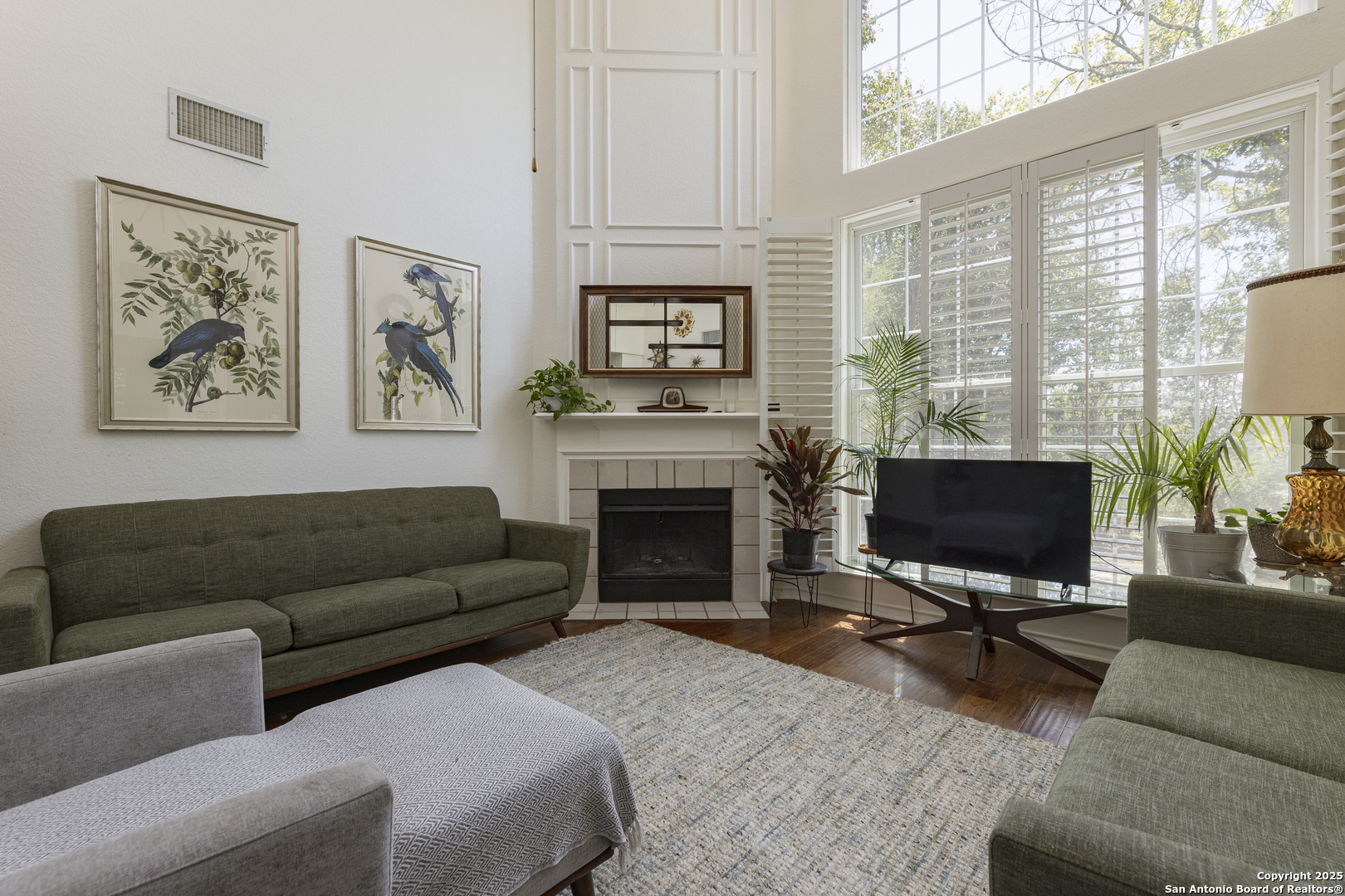 922 Hedgestone Drive San Antonio, TX 78258 - Photo 3 of 40 a living room with furniture a fireplace and a flat screen tv