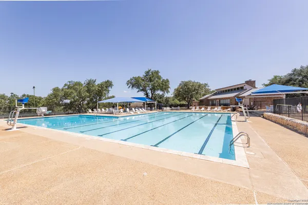 a view of a swimming pool and an outdoor seating
