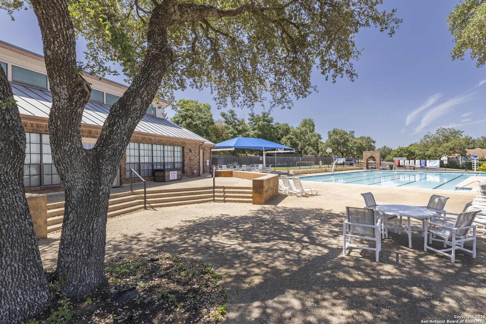 922 Hedgestone Drive San Antonio, TX 78258 - Photo 38 of 40 a view of a lake with a yard and large trees