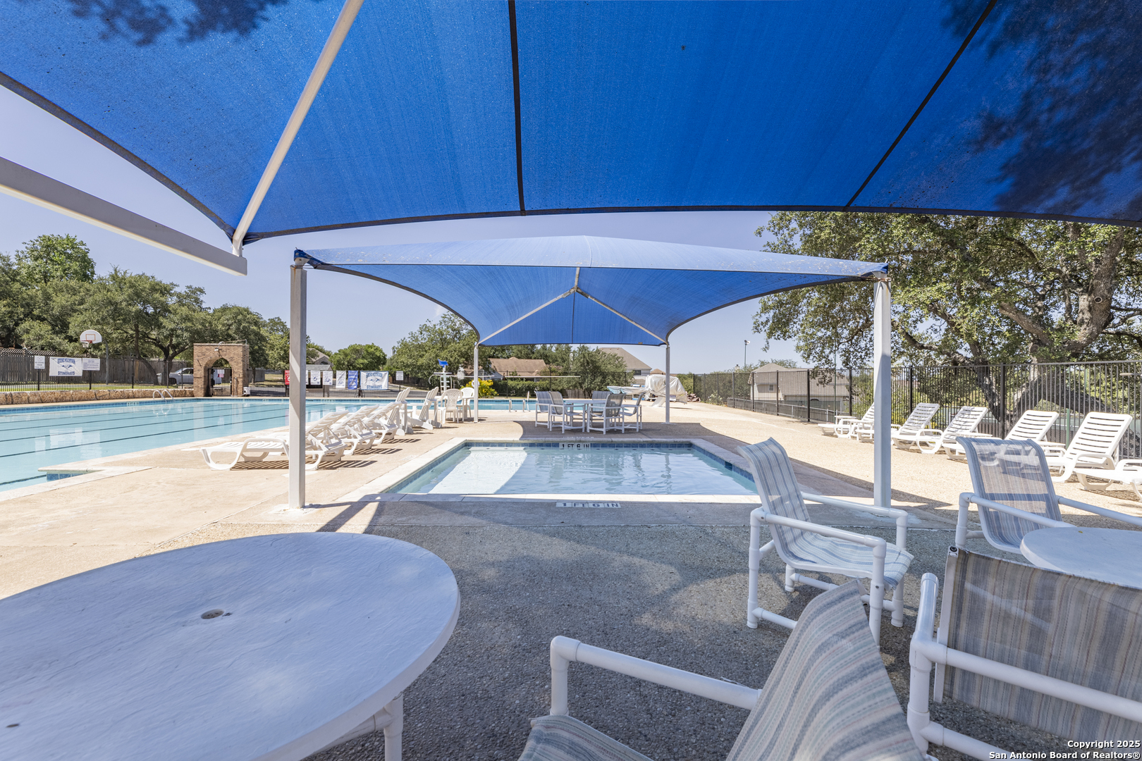 922 Hedgestone Drive San Antonio, TX 78258 - Photo 39 of 40 a view of a patio with a table and chairs under an umbrella