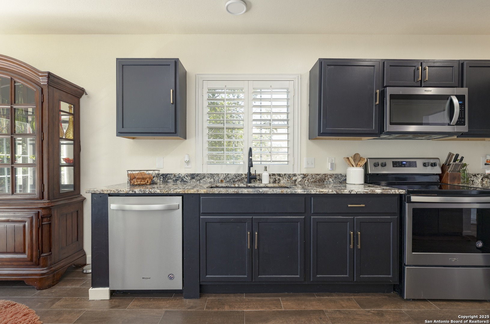 922 Hedgestone Drive San Antonio, TX 78258 - Photo 4 of 40 a kitchen with stainless steel appliances granite countertop a stove microwave and sink